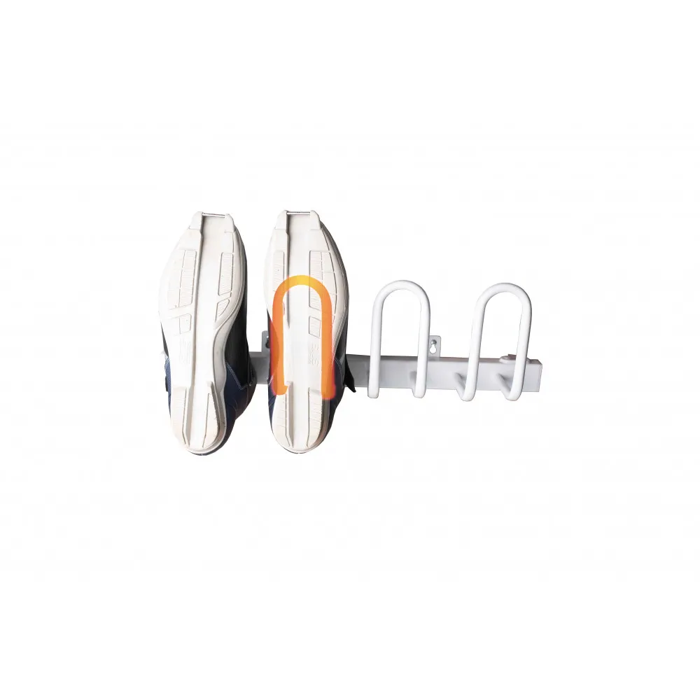 Two shoes, soles up, hanging on a white shoe dryer with three hangers. One hanger is highlighted.
