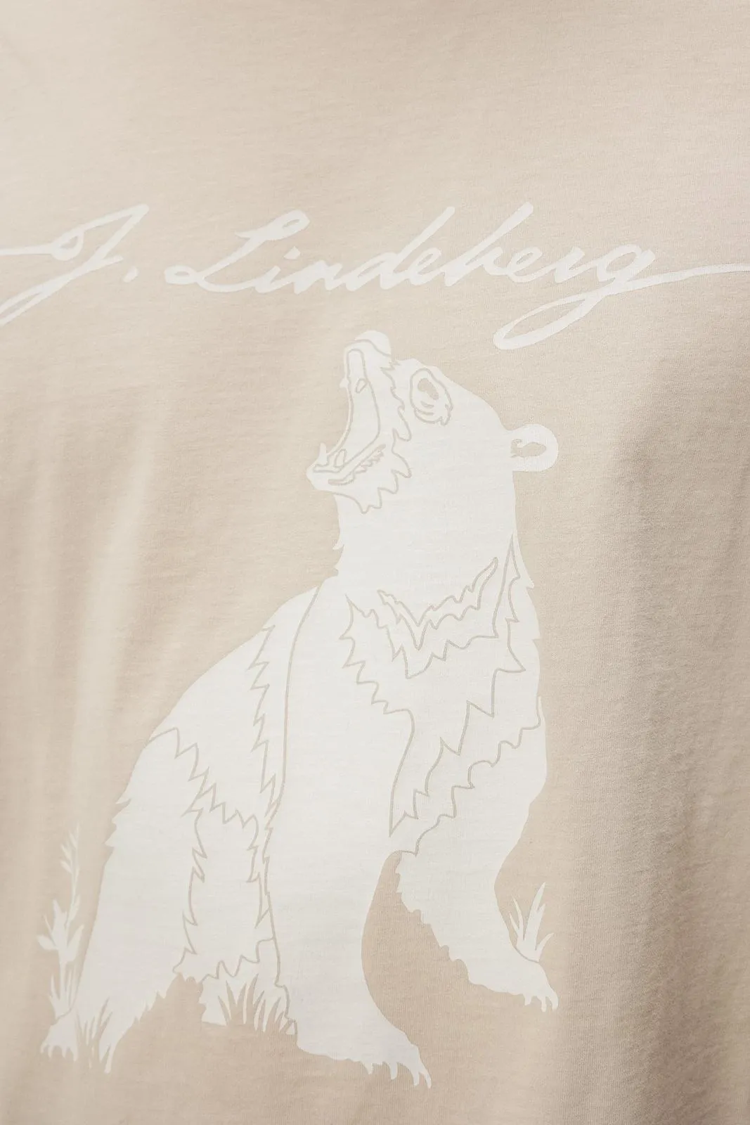 Close-up of a T-shirt in Oyster Gray, printed with a bear and the words "J.Lindeberg".