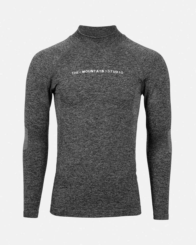 A gray, long-sleeved sports top with a stand-up collar and "THE MOUNTAIN STUDIO" lettering on the chest.