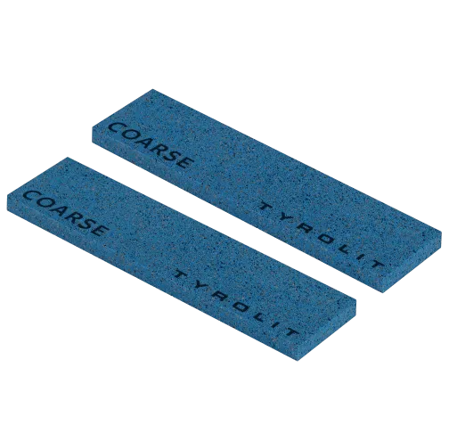Two rectangular, blue whetstones with the inscription "COARSE" and "Tyrolit" lie parallel to each other.