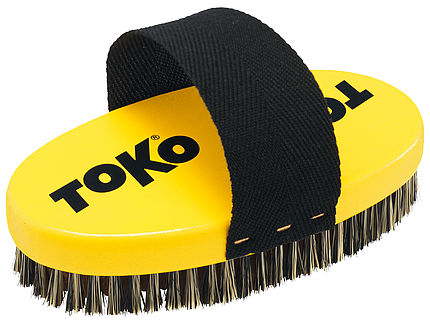 Gelbe Toko Bürste mit schwarzen Borsten und Halteband. Oval mit Logo.