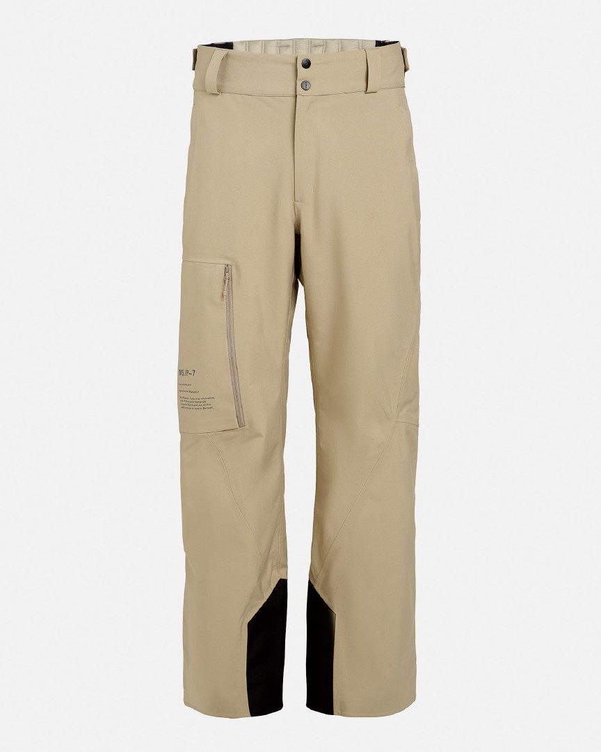 Seneca Rock Ride Insulated Pant: Beige, isolierte Skihose mit schwarzen Verstärkungen an den Beinenden.