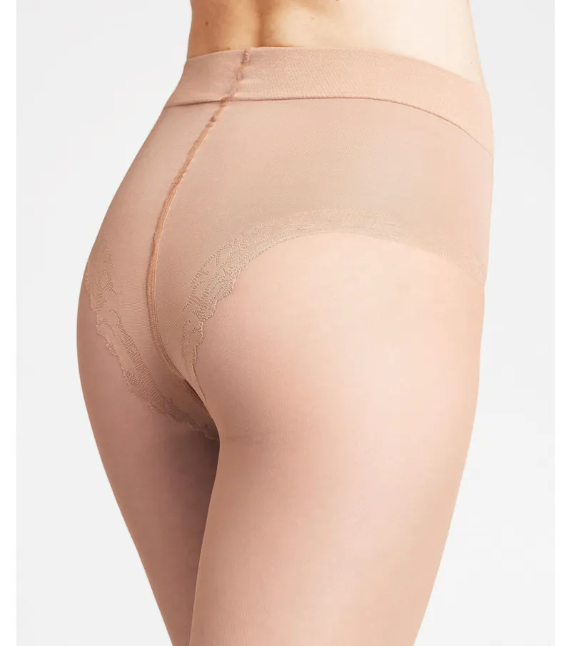Close-up of a woman wearing Cocoon shaping top 20 DEN tights.