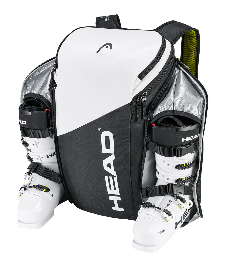 Sac à dos Head Rebels blanc et noir avec chaussures de ski dans des compartiments séparés.