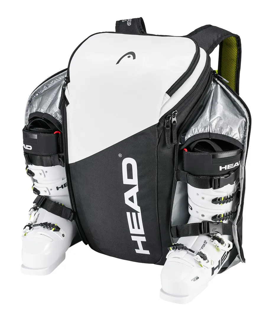 Sac à dos Head Rebels blanc et noir avec chaussures de ski dans des compartiments séparés.