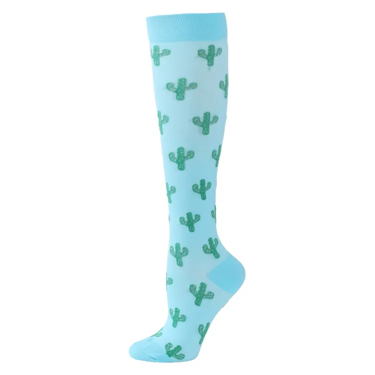 Turquoise ski sock with a repeated green cactus pattern. The sock reaches to the knee.