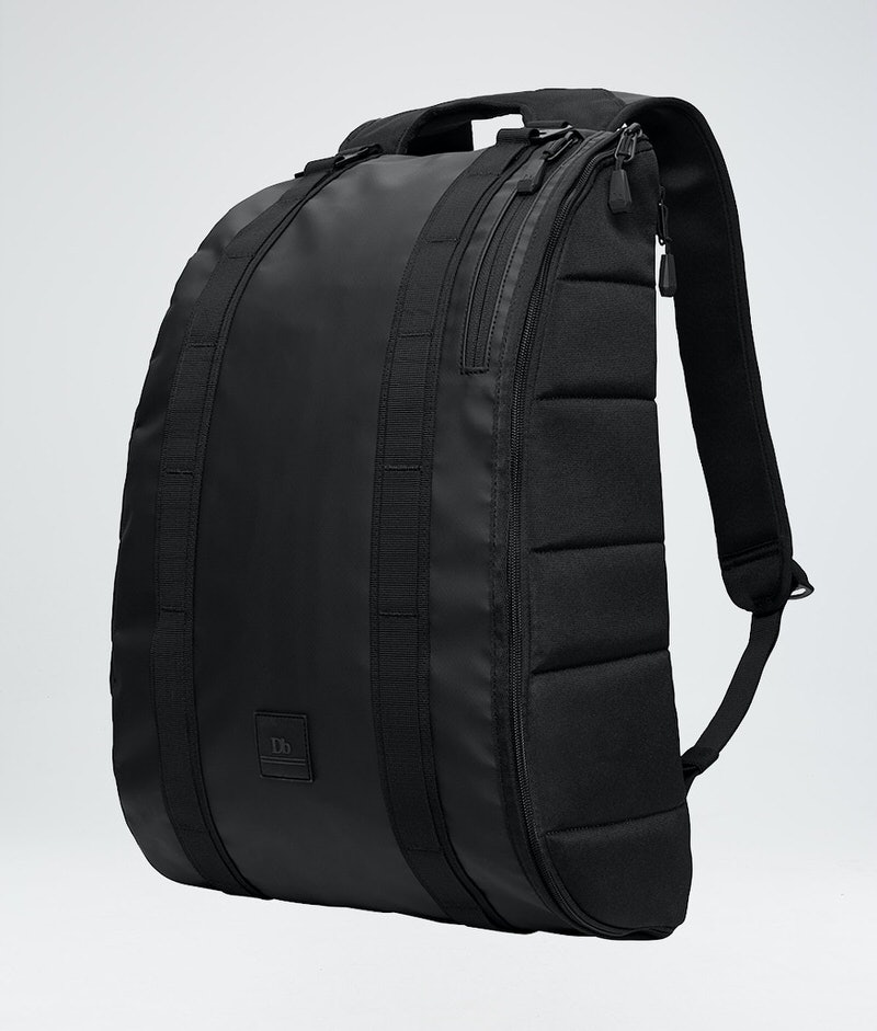 Douchebags The Base backpack Black Douchebags The Base 15L backpack, side view, carrying handle and shoulder straps visible.