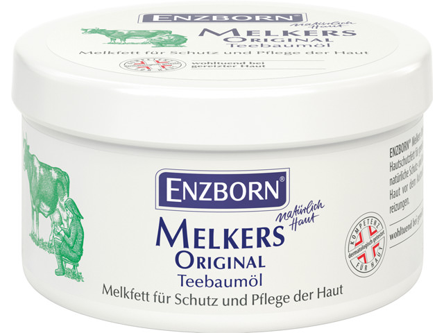 Boîte Enzborn Melkers Original Tea Tree Oil, avec illustration d'une vache et d'une trayeuse. Graisse à traire pour la protection et le soin de la peau.