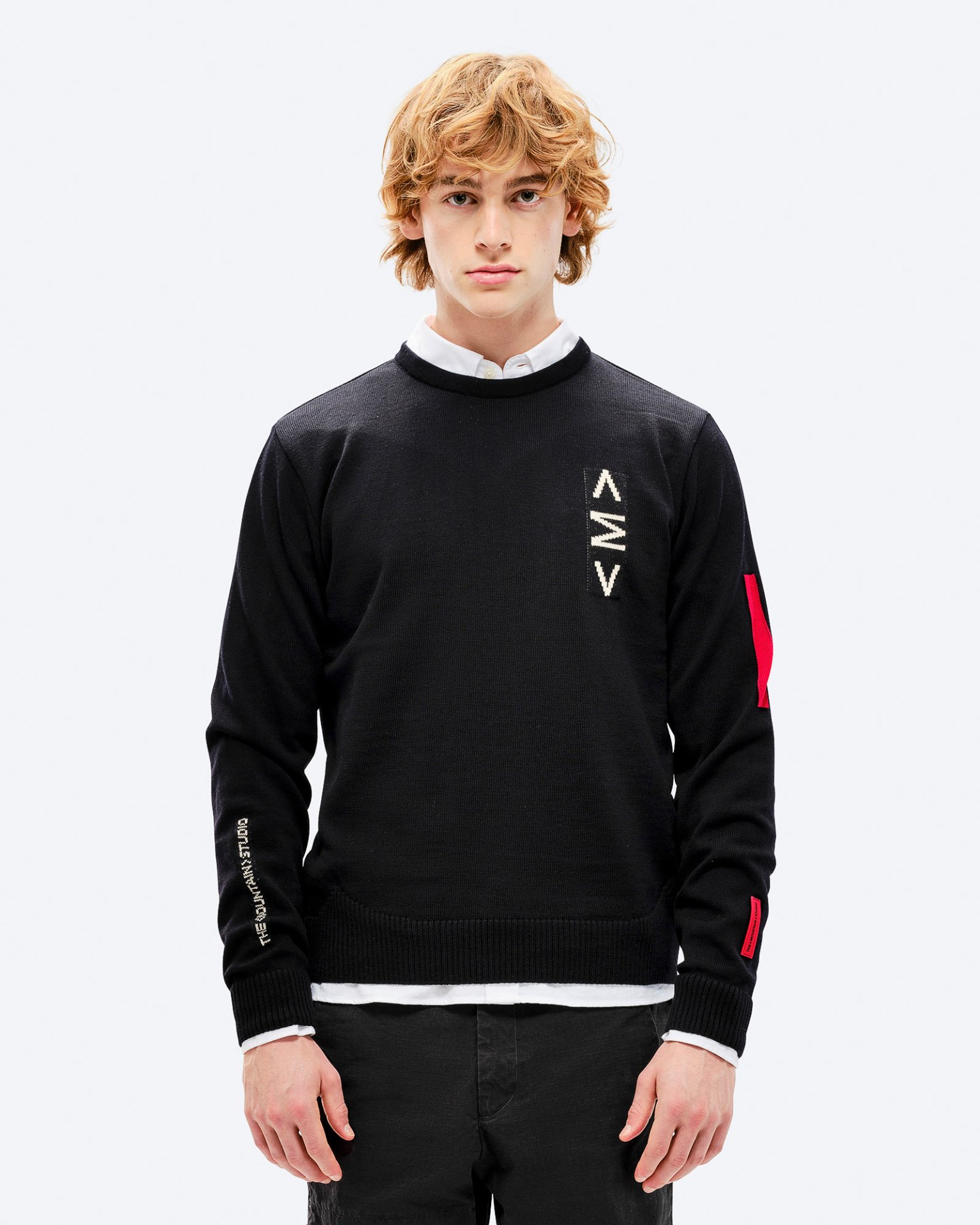 Black K-3 ski sweater Man wearing black K-3 ski sweater with intarsia knit pattern and round neckline against a white background.
