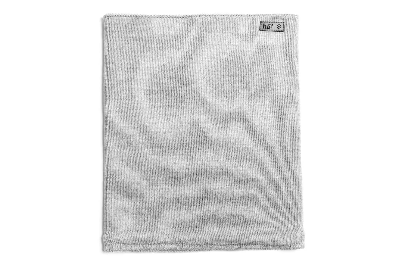 Gray drifter merino neck warmer made of knit with label on the top right.