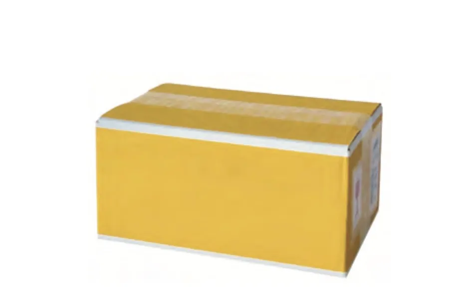 A yellow, taped-up cardboard box with imprint containing the Toko Barwax Performance Universal 2.5 kg product.