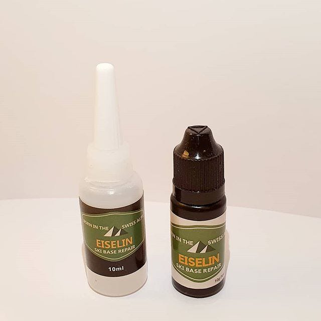 Zwei Flaschen Ski Base Repair Set, eine weiße und eine braune Flasche mit Etikett der Marke Eiselin.