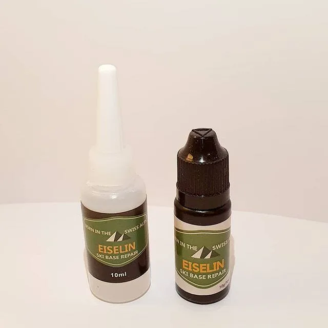 Zwei Flaschen Ski Base Repair Set, eine weiße und eine braune Flasche mit Etikett der Marke Eiselin.