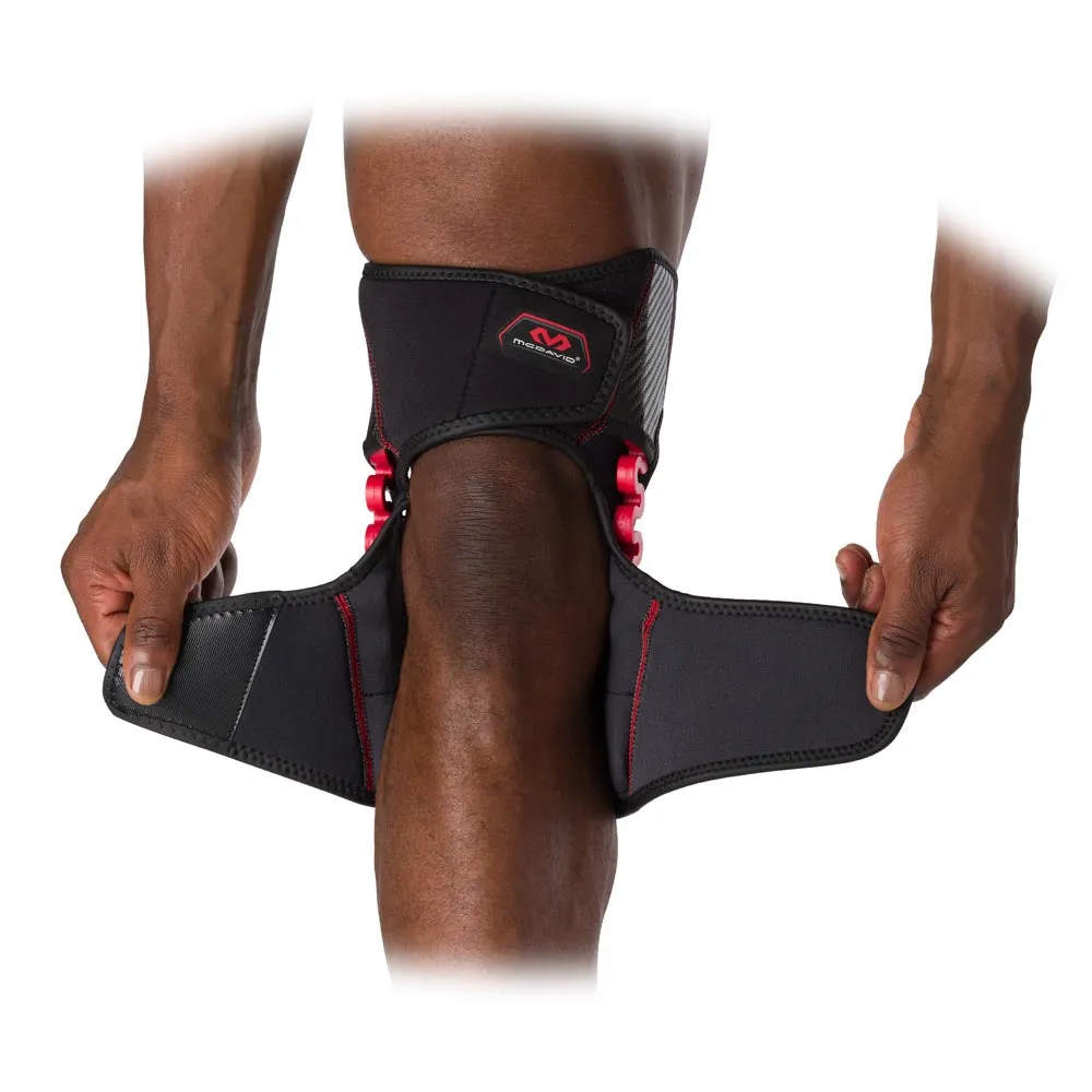 Knee with McDavid NRG Knee Over Wrap Bandage that holds open Velcro straps in place.