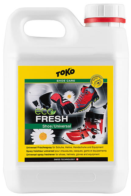 Bidon blanc Toko Eco Shoefresh avec étiquette jaune. Illustration des chaussures, du casque, des gants et des bottes de montagne sur l'étiquette.