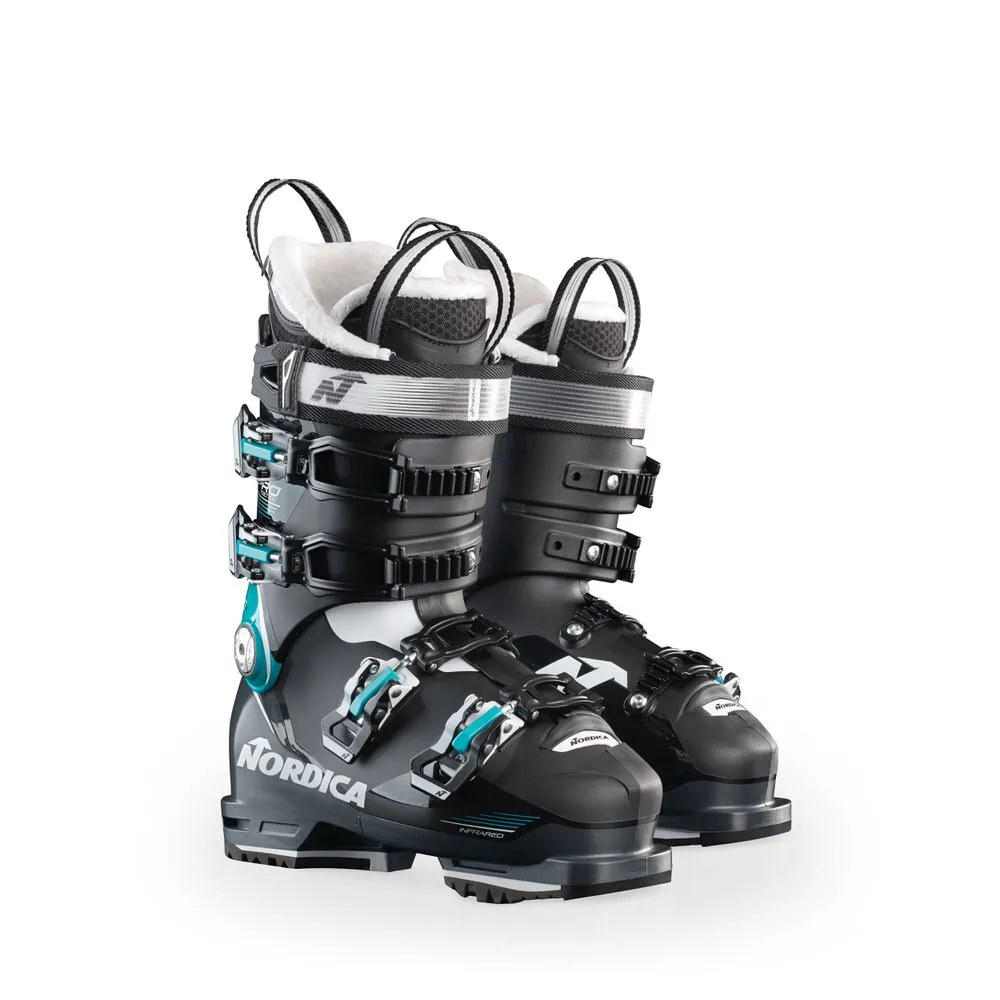 Black Nordica Pro Machine 95 W GW ski boots with turquoise accents and silver buckles.