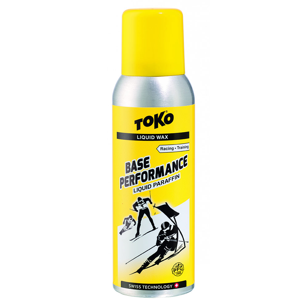 Gelbe Flasche Toko Base Performance Liquid Paraffin mit Skifahrer-Illustration.
