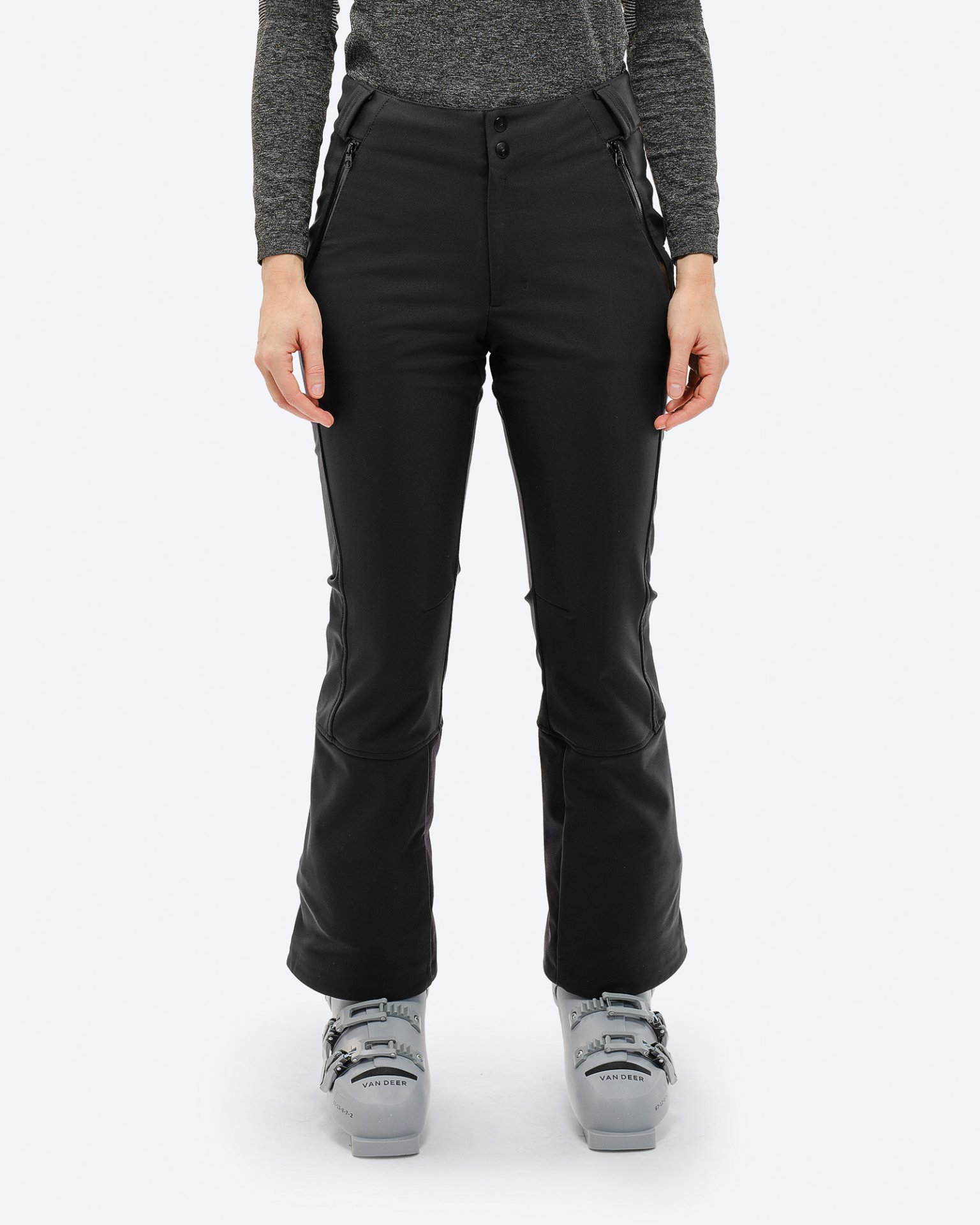 Black ski pants 2L Person wearing black P-4 W 2L stretch ski pants and ski boots against a neutral background.